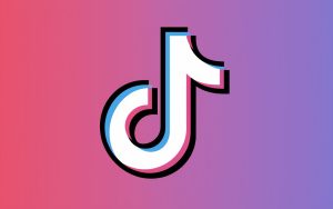 An illustration of the TikTok logo with a smiley face. The background is a gradient of pink and purple.