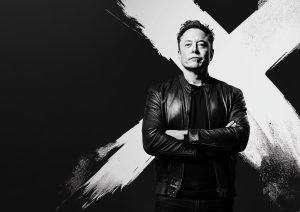 Black and white Elon Musk standing in front of a large white 'X' on a dynamic background