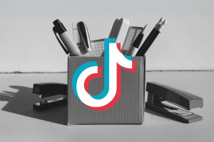 ByteDance lays off hundreds as TikTok shifts toward AI content moderation. TikTok logo in front of box with office goods showing redundancy