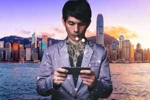 Hong Kong unveils AI finance and possible crypto tax break policy. Man holds phone with bitcoin appearing from it, with Hong Kong skyline in the background