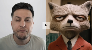 Screenshot of a video of a man side by side with a fox/animal. The animal, on the right, is dressed in an orange suit. Both are pulling a glum expression.