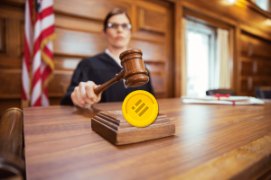 Former Binance employee sues for bribery, whistleblowing, and unfair dismissal. Judge uses gavel above Binance token