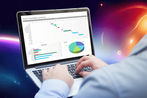 Microsoft denies claims of using Word and Excel data for AI training. Person working on a laptop displaying a project management dashboard, including a Gantt chart, pie chart, and bar graphs, against a cosmic background with vivid colors and stars.