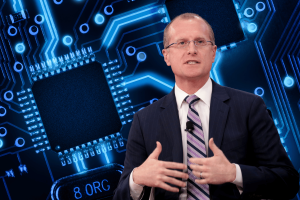 Trump picks Brendan Carr to lead FCC, targeting Big Tech and censorship. Brendan Carr in a dark suit and striped tie, wearing glasses, in front of a futuristic blue background depicting Big Tech