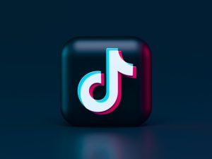 Black background with TikTok bubble logo in the center.