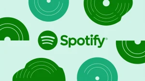 A Spotify logo with the text "Spotify" in green. There are green circles with white lines radiating out from the center of the logo. Some of the green circles have a white dot in the middle.