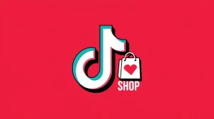 A TikTok Shop logo with a red background and the text "TikTok Shop" in white. There is a white shopping bag with a pink heart in the corner. The logo has a glossy effect.