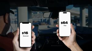 Two arms in view in a car holding a phone. It includes a white screen with a price on it.