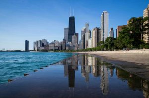 Cityscape image of Chicago, can see the water to the left and buildings in the background.