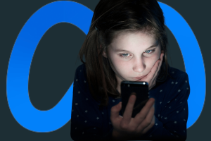 Meta partners with Childhelp to help kids avoid groomers online. A young girl with a concerned expression looks at her smartphone in a dimly lit setting, with the Meta logo in the background.