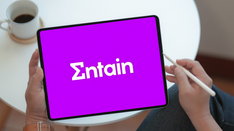 Entain logo on a tablet in a cafe setting
