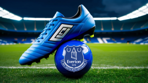 Blue football boot on top of a blue Everton UK football amidst a green field within a stadium