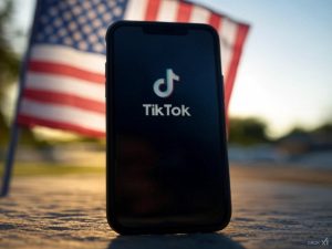 AI image to depict TikTok app with an American flag background / TikTok hits US staff with strict RTO policy.