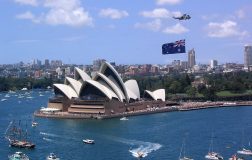 Sydney Opera House with an Australian flag next to it
