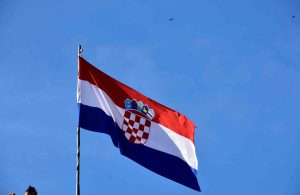 Blue sky in the background, Croatian flag on a pole.