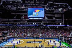 A big crowd gathered around a basketball tournament.