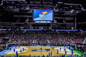 A big crowd gathered around a basketball tournament.