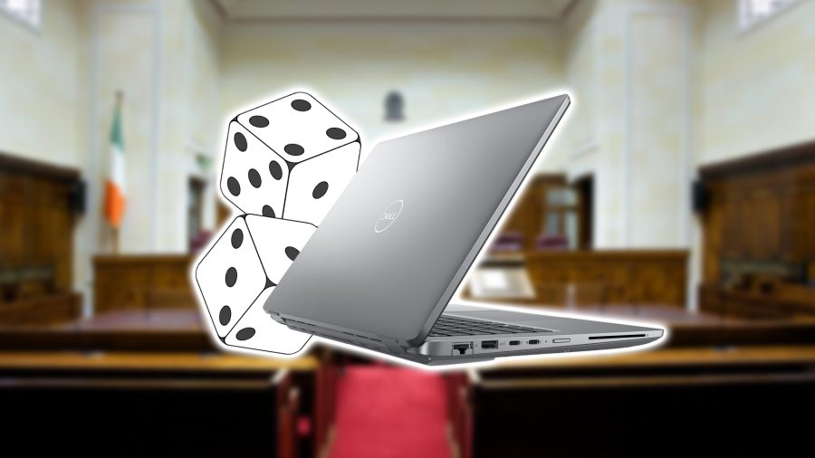 dell laptop with dice behind it over blurred image of court