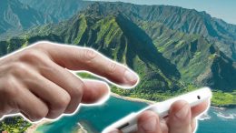 hand with phone over island in hawaii