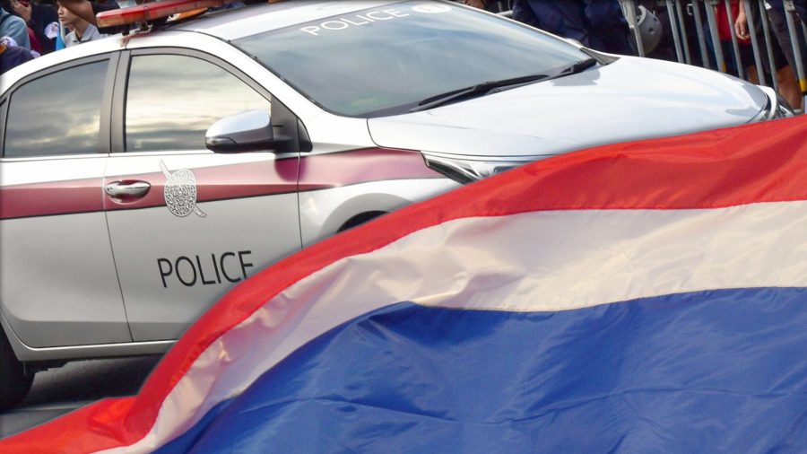 thailand police car with thai flag in front of it