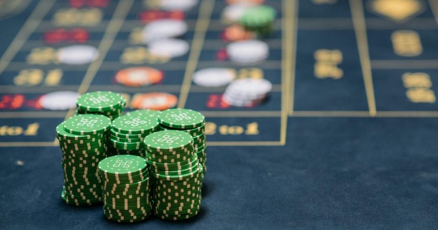 Green gaming casino chips on a blue background