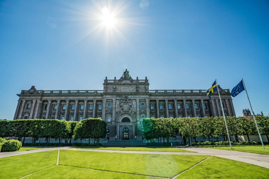 A Stockholm palace in the sunshine with the national and EU flags flowingHacksaw Gaming reportedly exploring IPO in Stockholm