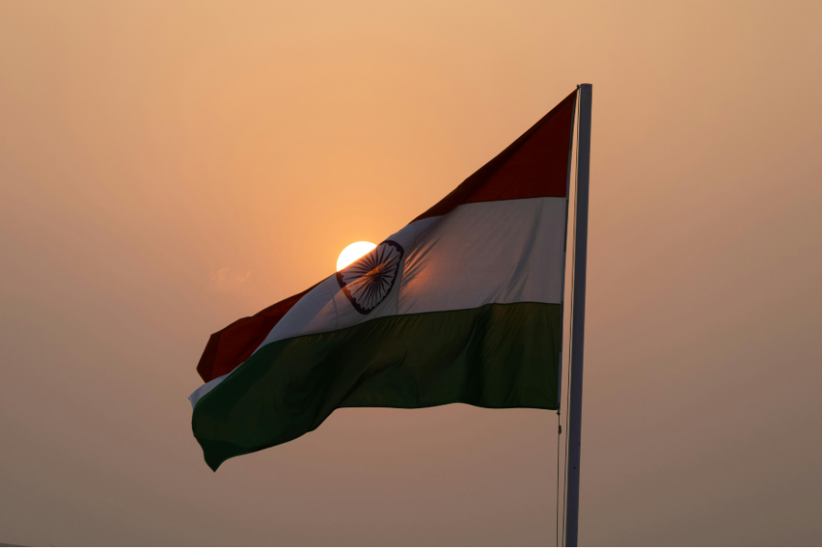 The flag of India billowing under a sunset