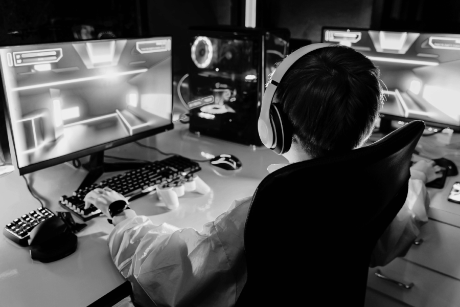 Create black and white image of children gaming and buying loot boxes. Black and white image of a child gaming online.