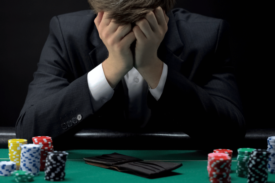 Experts question gambling suicide stats used to justify stricter regulation in the UK. Young devastated businessman losing poker game at casino, gambling addiction