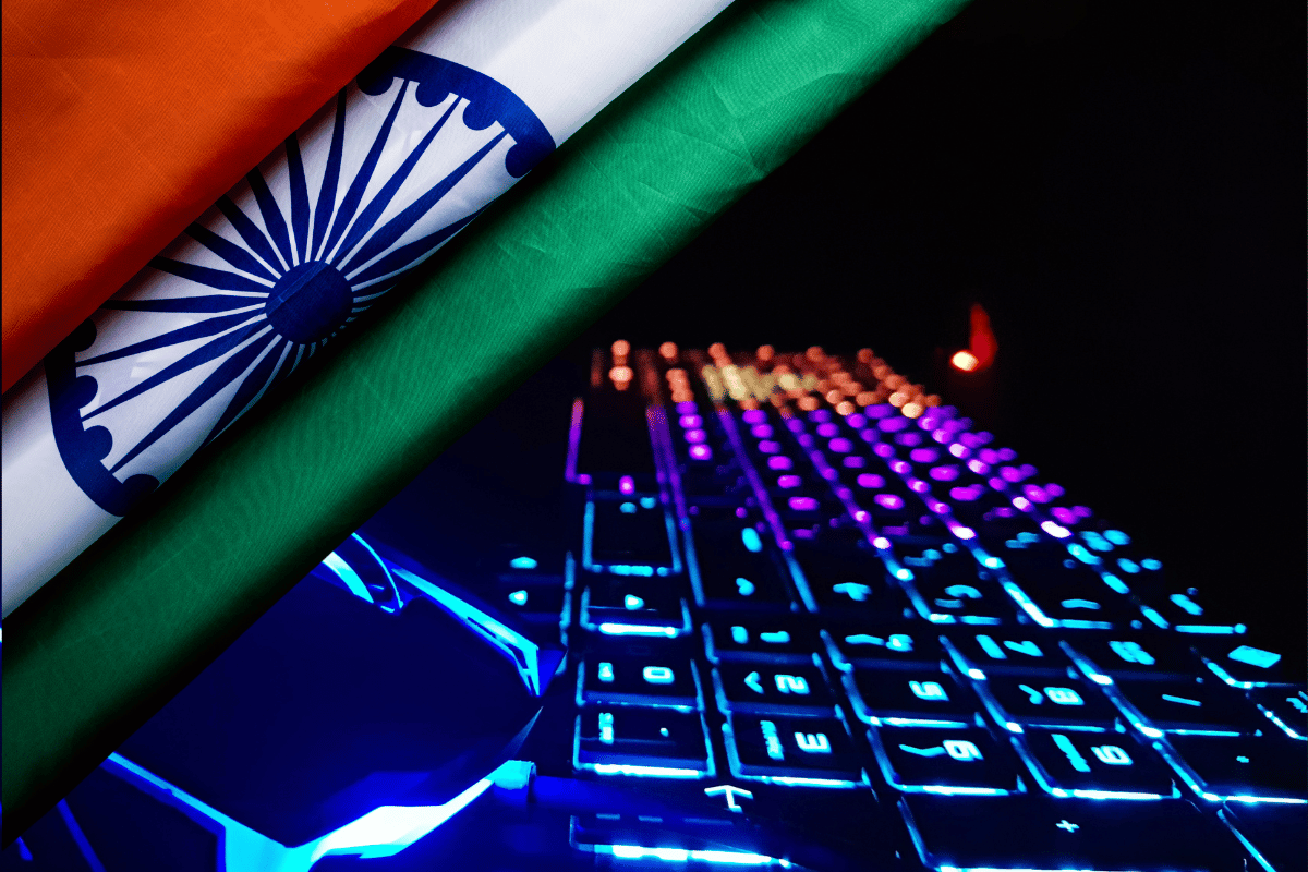 India debates whether online gaming equals gambling in court. Indian flag partially covering a brightly lit RGB gaming keyboard and mouse, symbolizing the intersection of national regulation and the online gaming industry in India.