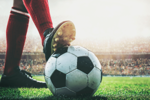 Major soccer clubs warned over by UK Gambling Commission as TGP Europe exits country. Person with soccer ball