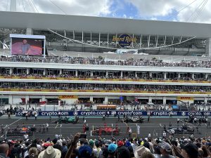 Formula 1 Miami Grand Prix, starting grid. Camn see four cars lined up on the grid.