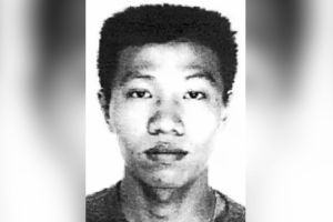 Nine years' jail for former police officer on the run for 17 years. Koh Kian Tiong mugshot in black and white.