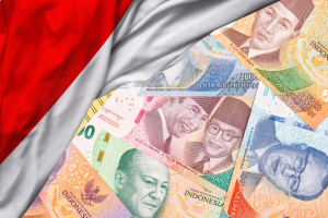 Over 28,000 bank accounts blocked in Indonesia’s online gambling crackdown. Red and white Indonesian flag with various rupiah notes.