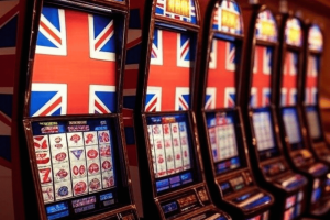 Slot machine companies 'target poorest areas in the UK,' as profits go offshore - report. Slot machines with Union Jack on screens.
