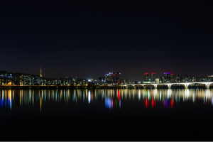 A South Korean skyline lit at night across the water