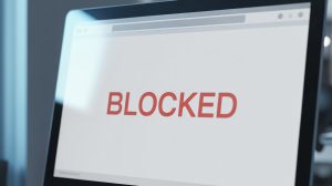 Record number of illegal gambling sites blocked by Danish Gambling Authority. A photograph of a computer screen displaying a stark white digital page, dominating the frame. Prominently centered on the screen, the words 