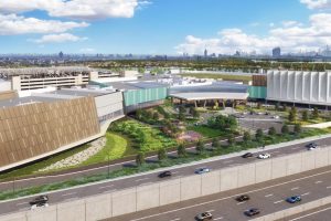 MGM casino in New York, large building with roads in front of it. Blue sky with clouds.