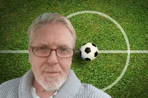 Former Sky Sports presenter banned after football betting firm lost $13.5M. Alan Bentley in front of football pitch with soccer ball