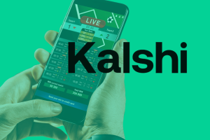 IGA chair calls Kalshi CEO ‘lying little twerp’ in dispute with tribes. A person holding a smartphone displaying a live sports betting interface, with the word 