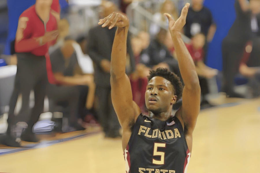 Malik Beasley investigation: NBA star accused of gambling-related irregularities. Florida State basketball player wearing jersey number 5 takes a jump shot during a game, with teammates and spectators in the background.