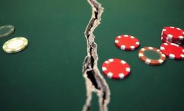 A casino table is ripped in two amongst poker chips
