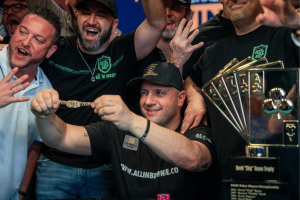 Turnouts and wins WSOP 2025 sees history made. Michael Mizrachi celebrates his WSOP 2025 victory surrounded by cheering supporters. He holds up a gold bracelet with a big smile as others gesture excitedly. A large trophy featuring playing card suits and the text “David ‘Chip’ Reese Trophy” is visible on the table.