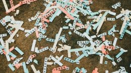 A range of raffle tickets lay on the ground in many colours