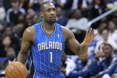 Former NBA star Gilbert Arenas arrested under suspicion of operating illegal poker games. Former NBA player Gilbert Arenas in an Orlando Magic jersey dribbling the basketball during a game, with spectators in the background.