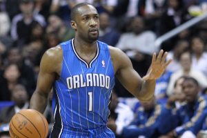 Former NBA star Gilbert Arenas arrested under suspicion of operating illegal poker games. Former NBA player Gilbert Arenas in an Orlando Magic jersey dribbling the basketball during a game, with spectators in the background.