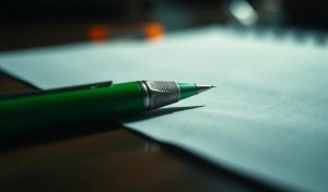 A green pen on a piece of paper. Irish study links problem gambling to bonus offers