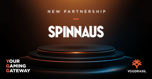 Yggdrasil logo in the bottom right, dark background with 'Spinnaus' written in the centre