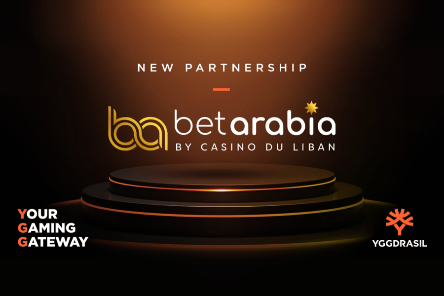 Yggdrasil partners with BetArabia to launch premium slots in Lebanon. Yggdrasil and BetArabia announce new partnership with logos on a dark stage background. Text reads: New Partnership, BetArabia by Casino Du Liban, Your Gaming Gateway, and Yggdrasil.