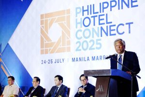 CEO from Philippine's regulator PAGCOR is stood on stage, can see four other men sat behind him. Philippines' integrated resort casinos generated $1.6 billion in first half of 2025